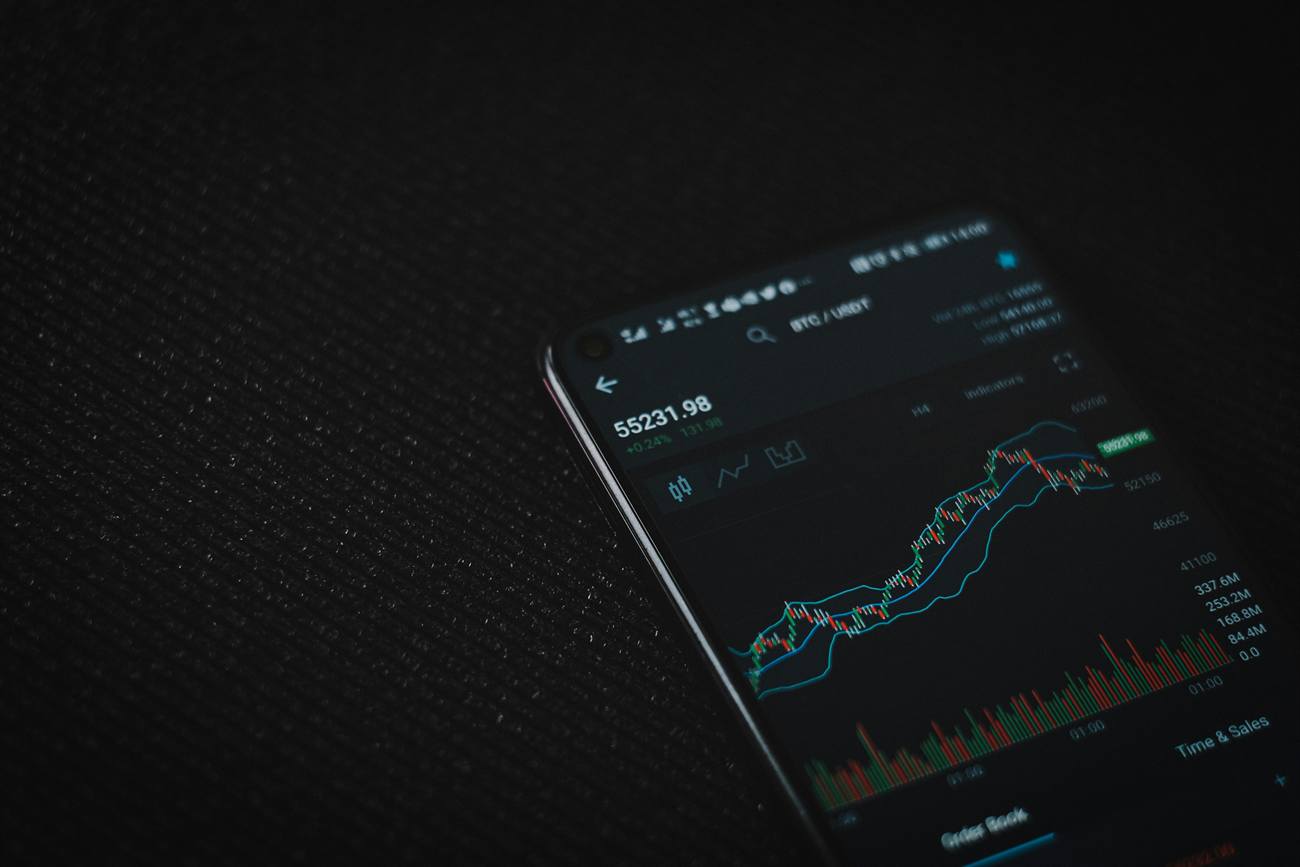 Trading app on a phone showing live charts